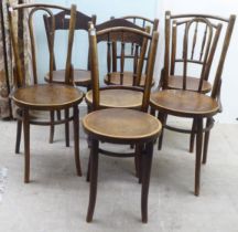 A set of three early 20thC Mundis bentwood chairs with solid, stencilled seats; and two similar