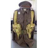 A British Army tunic with webbing belts; and a peaked cap (Please Note: this lot is subject to the