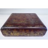 An early 20thC Chinese brown and gilded lacquered wooden table casket, the lid enclosing a series of