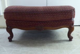 A modern diamond formation pattern fabric upholstered footstool, raised on cabriole legs