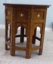 An early 20thC North African hardwood side table, intricately inlaid in bone and mother-of-pearl