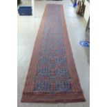 A machine made two sided tapestry style long panel/runner  40" x 252"