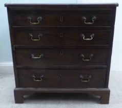 A George III mahogany bachelor's chest, the top with re-entrant corners, over a brushing slide and