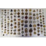 Approx. fifty-five military cap badges and other insignia, some copies: to include 19th PWO Hussars;