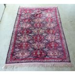 A part silk woven Persian rug, decorated with repeating starburst motifs, on a multi-coloured ground