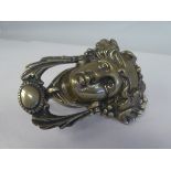 An Art Nouveau period cast brass door knocker, fashioned as a female head, adorned with leaves and