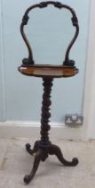 A Victorian walnut dressing room pedestal table with a carved upstand glazed frame, on a scalloped