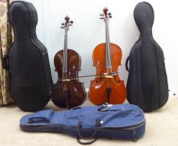 A modern quarter size and a half size cello with fabric carrying cases; and another (empty) fitted