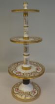 A late 19thC floral painted and gilded china three tier stand, on a circular base  16"h