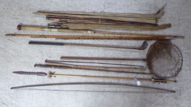 A spear; a longbow; and fishing rods