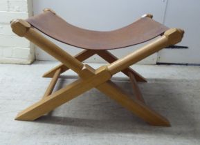 A modern light oak framed and hide panelled stool