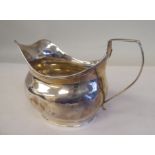 A William IV silver cream jug of oval, bulbous form with an applied wire rim and loop handle