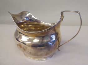 A William IV silver cream jug of oval, bulbous form with an applied wire rim and loop handle