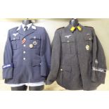 Two dissimilar German World War II style military tunics with emblems (Please Note: this lot is