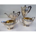 An Edwardian four piece silver tea set of pedestal lamp design, comprising a teapot with a swept