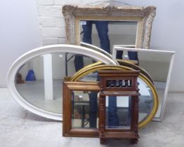 Six dissimilar early 20thC variously framed mirrors  largest 16" x 22"
