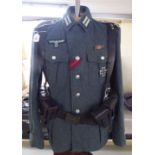 A German World War II design military tunic with emblems and an associated ammunition belt (Please