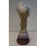 A Lladro porcelain model, a football World Cup trophy, on an associated plinth  15"h overall