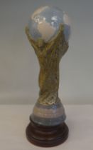 A Lladro porcelain model, a football World Cup trophy, on an associated plinth  15"h overall