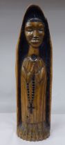 A late 19thC Portuguese carved and stained church ikon, a standing robed figure, in a niche  17"h