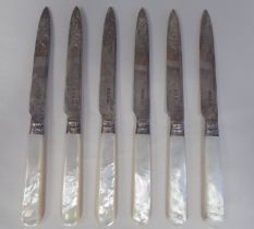 A set of six Edwardian foliate engraved scrolled silver tea knives, on abalone handles