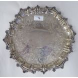 A late Victorian silver salver with a raised, C-scrolled and shell cast border and conforming
