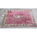A Persian machine made carpet, profusely traditionally decorated with birds and flora, on a multi-