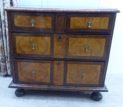 An 18thC figured and inlaid walnut dressing chest, the top with a cushion moulded border, over two