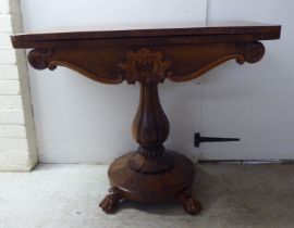A William IV rosewood card table, the rotating foldover top raised on a bulbous, reeded, pedestal,