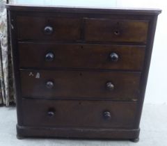 A late Victorian mahogany dressing chest, the two short/three long drawers with bun handles  42"h