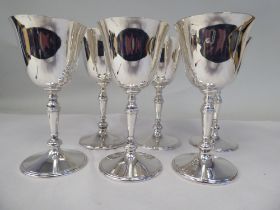A set of six silver inverted bell design wine goblets, each elevated on a knopped, tapered stem