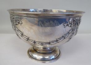 A silver rose bowl with an applied wire rim and embossed ribbon tied garlands, elevated on a domed