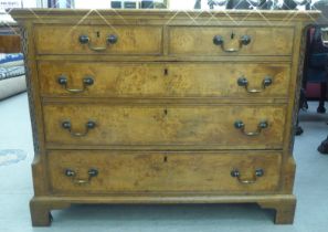 A George II and later walnut and oak dressing chest with two short and three long drawers, flanked