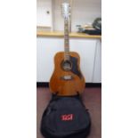An Eko Italian made, twelve string acoustic guitar with a stand and soft fabric case