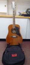 An Eko Italian made, twelve string acoustic guitar with a stand and soft fabric case