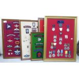 Five framed displays of replica medals and fabric badges  (Please Note: this lot is subject to the