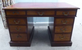 A late Victorian mahogany nine drawer on a twin pedestal desk with a tooled oxblood coloured hide