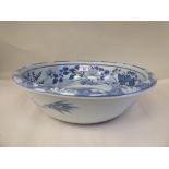 A 19thC Chinese porcelain bowl with a rolled rim, the blue and white ornament featuring playful