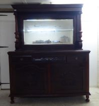 A modern reproduction of a Victorian mahogany dresser, the superstructure with a bevelled mirror