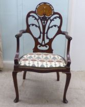 An Art Nouveau style Jones & Higgins mahogany framed chair with an open foliate scroll carved and