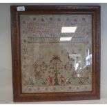 A 19thC sampler worked in coloured wool, incorporating the alphabet and Arabic numerals, figures,