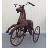 A vintage pedal action, painted wooden toy horse, on three spoked wheels  approx. 30"h