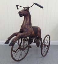 A vintage pedal action, painted wooden toy horse, on three spoked wheels  approx. 30"h