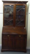 A George III mahogany bureau bookcase with two astragal glazed doors, the fall flap over a drawer