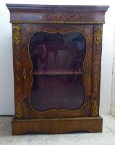 A late Victorian walnut and floral marquetry pier cabinet with ormolu gilt mounts, the glazed door