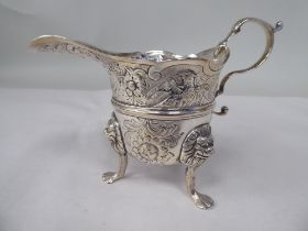 A late 18th/early 19thC Irish silver cream jug of cauldron form with a flared, decoratively cut