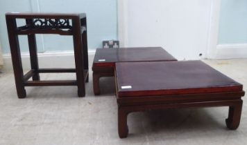 A pair of early 20thC Chinese Hongmu stands with detachable lacquered tops, raised on moulded square