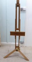 A stained pine and brass mounted folding studio easel