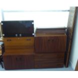 A mid 20thC mahogany finished, five piece modular wall unit with shelves