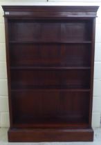 An early/mid 20thC mahogany four tier open front bookcase, on a plinth  62"h  40"w